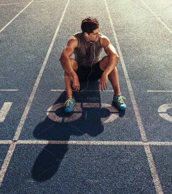 Athlete resting on a running track